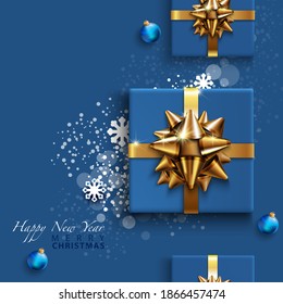 Merry Christmas. Background with realistic design with 3d Christmas decorations, blue gift box, bauble, golden metallic snowflake, ribbon. Composition top view flat-lay. Greeting card, banner, poster
