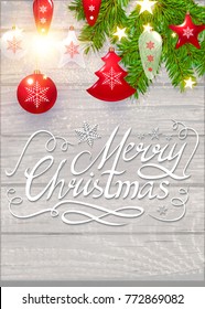 Merry Christmas Calligraphic Lettering on Elegant Soft Wood Textured Background with Golden Lights, Fir Tree Branches and Christmas Toys. Vector illustraion