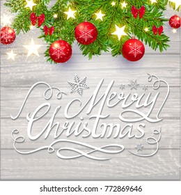 Merry Christmas Calligraphic Lettering on Elegant Soft Wood Textured Background with Golden Lights, Fir Tree Branches and Christmas Toys. Vector illustraion