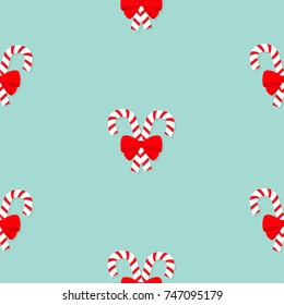 Merry Christmas Candy Cane stick with red bow. Seamless Pattern. Flat design. Blue background. Vector illustration.