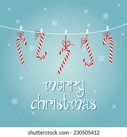 Merry christmas card with hanging candy canes