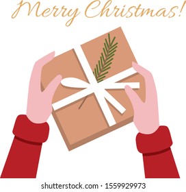 Merry Christmas card. Person holds a Christmas present in hands.  