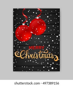 Merry Christmas card with red balls on dark wooden background. Christmas hand written caligraphy
