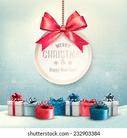 Merry Christmas card with a ribbon and gift boxes. Vector.