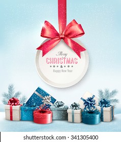 Merry Christmas card with a ribbon and gift boxes. Vector.
