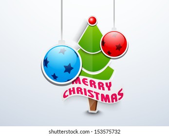 Merry Christmas celebration background with Xmas Tree and hanging decorated Xmas balls on blue background. 