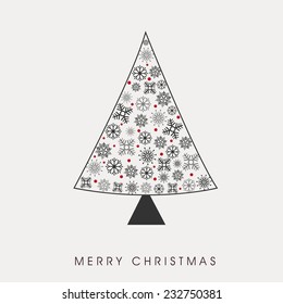 Merry Christmas celebration concept with beautiful snowflakes decorated X-mas tree on grey background.