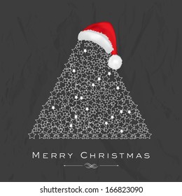 Merry Christmas celebration flyer, banner, poster or invitation with shiny floral decorated Xmas tree and Santa Hat on grungy grey background. 