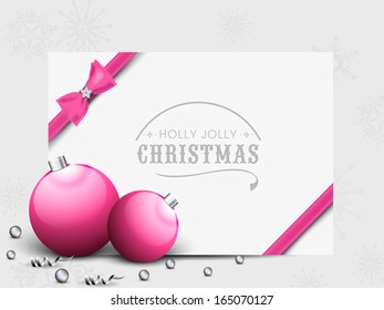 Merry Christmas celebration gift card with Christmas balls in pink color and ribbon on abstract grey background. 