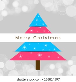 Merry Christmas celebration greeting card or invitation card with colorful Xmas tree on shiny grey background. 