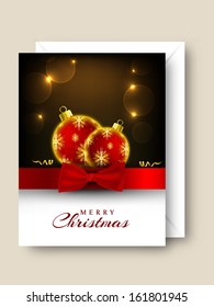 Merry Christmas celebration greeting or gift card with golden and red Xmas balls, red ribbon on shiny brown background.