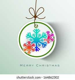 Merry Christmas celebration sticker, tag or label decorated with colorful snowflakes on green background. 