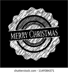 Merry Christmas chalk emblem written on a blackboard