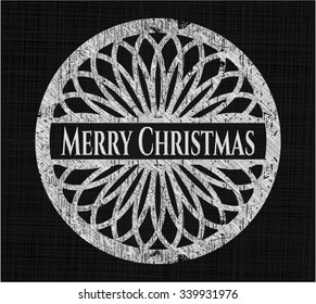 Merry Christmas chalk emblem written on a blackboard
