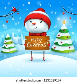 Merry Christmas! Cheerful snowman holds wooden board sign in Christmas snow scene winter landscape.