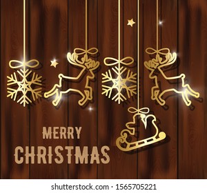 Merry christmas composition with golden decorations hanging. Snowflakes, reindeer, santa with sledge