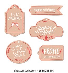 Merry Christmas in different languages. Paper gift tags set. Feliz Navidad in Spanish, Frohe Weihnachten in German, Joyeux Noel in French. Vintage hand lettering.