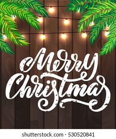 Merry Christmas flyer design with lights and pine branches, on wooden background, with custom brush hand lettering. Vector festive illustration.