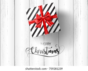 Merry Christmas Gift Box with Red Ribbon on White Wood Texture. Vector.