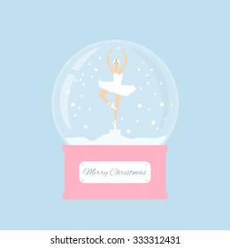 Merry christmas glass ball with a ballerina dancing in the snow. New Year gift.