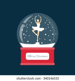 Merry christmas glass ball with a ballerina dancing in the snow. New Year gift.