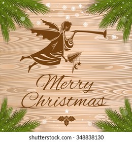 Merry Christmas Greeting Card with Angels and branches of spruce on a wood background.