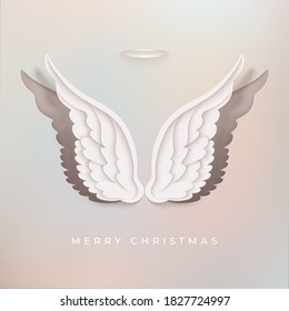 Merry Christmas greeting card. Layered paper style angel wings. Paper cut light pink backdrop. Vector illustration.