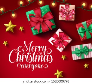 Merry christmas greeting card vector banner template. Merry christmas everyone typography in empty space with colorful elements of xmas gifts, lights and golden stars in night red background.