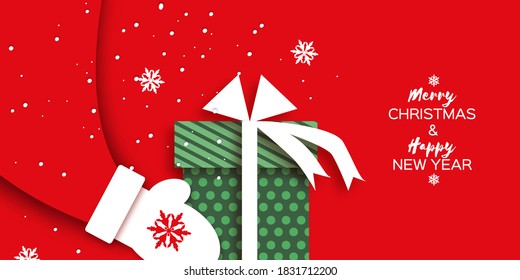 Merry Christmas Greetings Card with Santa Claus hands holding green giftbox with white bow. Happy New Year in papercraft style. Red background. Winter holidays.