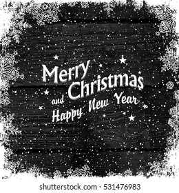 Merry Christmas Greetings. Wooden black christmas background with snowflakes. Frozen ornament isolated frame. Holiday Postcard template