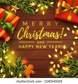 Merry Christmas and Happy New Year! Greeting card. Wooden background decorated with gifts, gingerbread man, Christmas tree branches and garland lights. Top view. Vector banner.