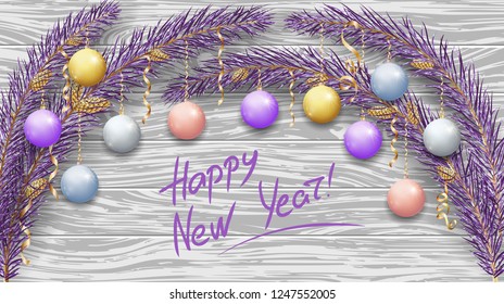 Merry Christmas and Happy New Year 2019. Purple branches of a Christmas tree in the snow. New Year's holiday decorations, garlands, tree cones, glossy balls and golden ribbons. Light woody background.