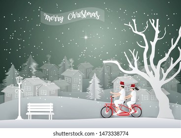 Merry Christmas and Happy new year concept with Couple riding a red bike in white Urban Countryside and snow in winter season, Paper art and Illustration style.