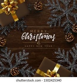 Merry Christmas and Happy New Year. Brown background from wooden boards, snowflakes with glitter sparkle, realistic pine cones, holiday gift boxes. Xmas composition Wood texture. Flat lay, top view.