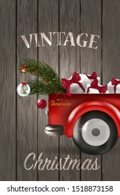 Merry Christmas and Happy New Year with red truck and christmas tree. Snowy forest on wooden background.