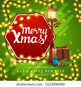 Merry Christmas and Happy New Year, square green greeting card with pole lantern, gift, Christmas tree branch with a cone and a Christmas ball