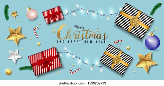 Merry Christmas and Happy New Year greeting card design with top view of baubles, gift box, stars and lighting garland decoration on soft blue background.