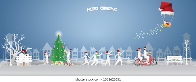 Merry Christmas and Happy new year with Couple riding a bike and Children are running,playing in winter season and Santa Claus and reindeer in a balloon shaped Santa hat floating on the sky.