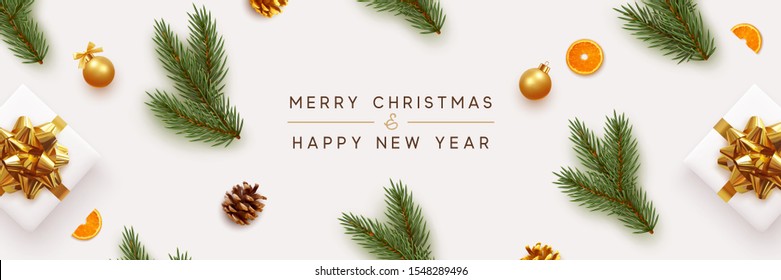 Merry Christmas and Happy New Year banner. Xmas background with realistic festive decorative design elements. Pine and spruce branches, gift box, pine cone, orange, ball bauble. Flat lay, top view.