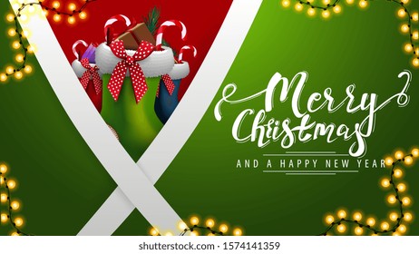 Merry Christmas and happy New Year, green postcard with diagonal white lines and Christmas stockings behind