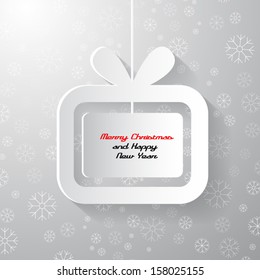 merry christmas and happy new year theme. present, gift box made from paper on grey background with snowflakes.