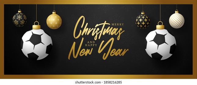 Merry Christmas and Happy New Year luxury Sports greeting card. Soccer Football ball as a Christmas ball on black background. 