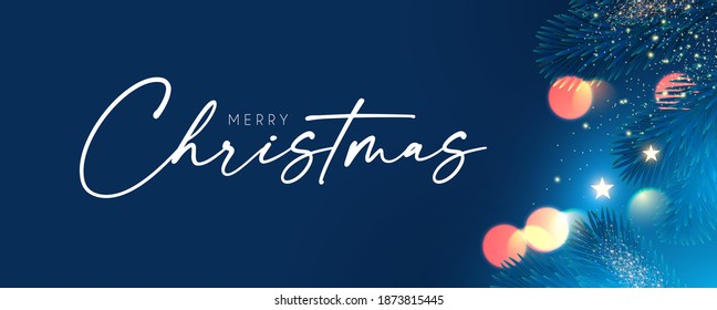 Merry Christmas and Happy New Year Holiday background with fir tree branches, bokeh effect and lights.