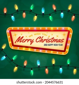 Merry Christmas and Happy New Year. Vintage marquee sign with illuminated frame. Green background, differently colored electric lights spaced evenly along a cable.