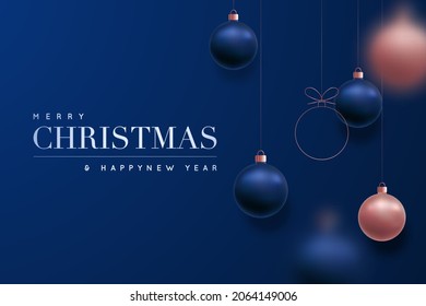 Merry Christmas and Happy New Year luxury background. Holiday dark blue background with hanging rose gold and blue balls. Christmas balls motion blur effect.