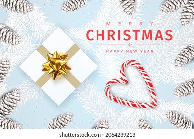 Merry christmas and happy new year. Christmas decorations. Festive bright design composition top view. Gift box with gold bow decoration, fir cones, candy canes forming a heart. Vector illustration