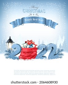 Merry Christmas and Happy New Year 2022. Blue 3D numbers with a red sack full presents on a winter landscape background. Vector