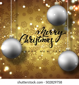 Merry Christmas and happy New Year greeting card. Golden background with Christmas balls and snowflakes. Hand Calligraphy for Xmas Holiday greeting card design.