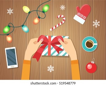 Merry Christmas and Happy New Year. Woman's hands give wrapped christmas  holiday handmade present in paper with red ribbon.  Wooden board. Banners. Flat vector illustration.