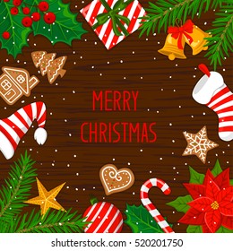 Merry Christmas and Happy New Year  winter  greeting card background with xmas decoration elements objects on old wood texture framed by fir branches. top flat lay view